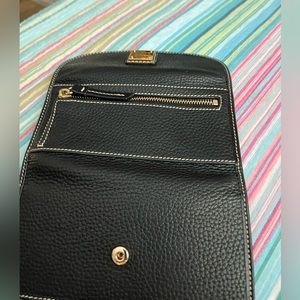 Dooney and Burke black , leather wallet.7 inches across, excellent condition